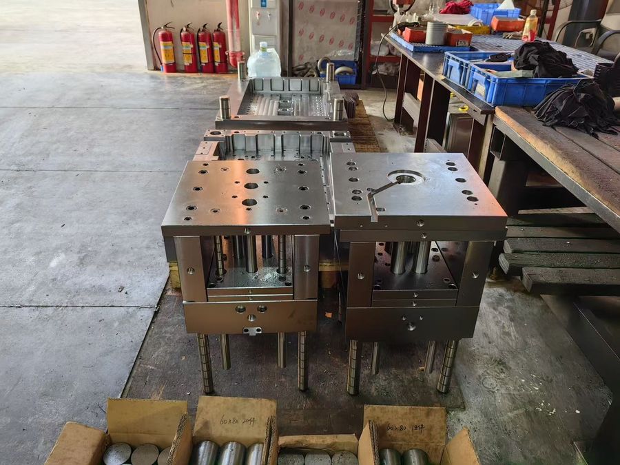 Finished mold bases staged on pallets on the workshop floor