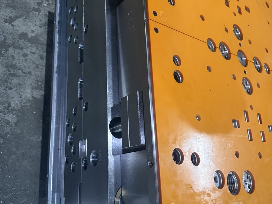 Mold base with orange side plates and lifting eye